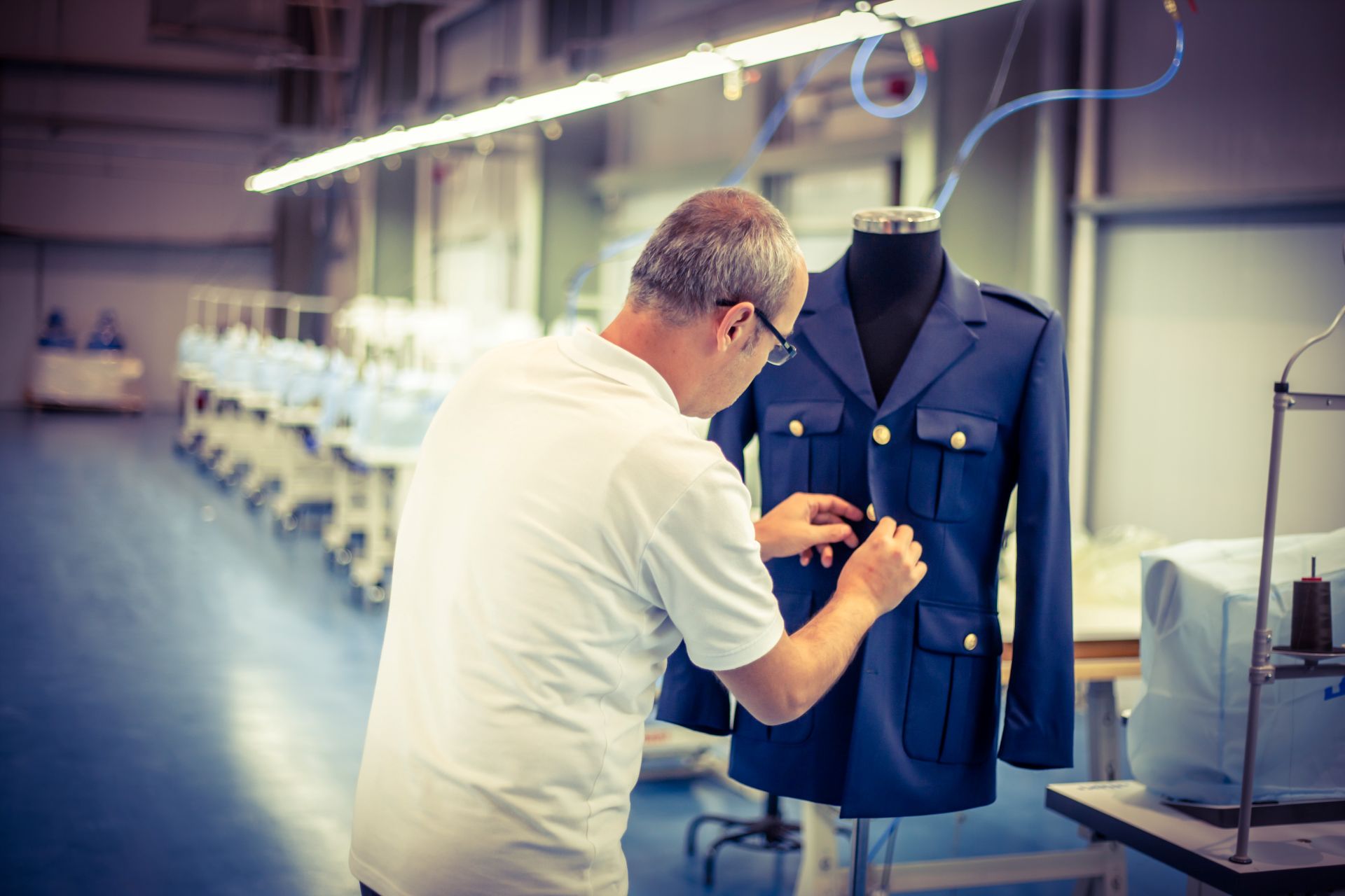 Uniform finishing on a ceremonial jacket inside the ATAAD factory.